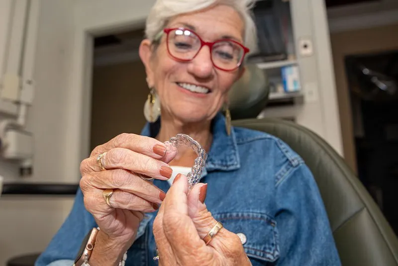 Nyla holding invisalaign aligners