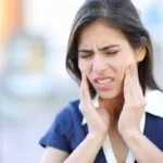 Woman suffering tmj complaining in the street