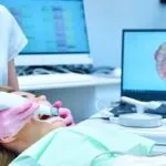 Woman dentist scaning patient's teeth