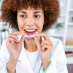 Joyful young woman undergoing clear aligner treatment